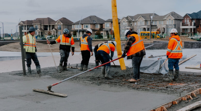 Concrete Flatwork and Slab Placement – GTA Construction Project Concrete flatwork crew placing and finishing reinforced concrete slab for a multi-unit residential development in the Greater Toronto Area.
